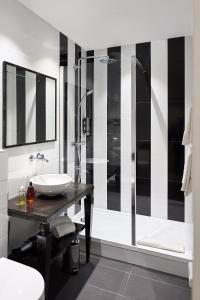 a bathroom with a sink and a shower at Hotel Arok in Strasbourg