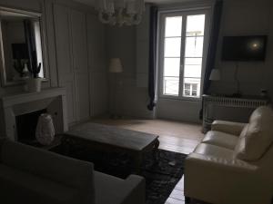 a living room with a couch and a coffee table at SAINT MALO Appartement in Saint Malo