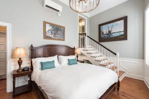 a bedroom with a large bed and a staircase at The Quarters on Vendue in Charleston