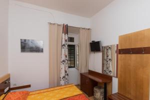 a small bedroom with a bed and a window at Kaboga street Rooms in Dubrovnik