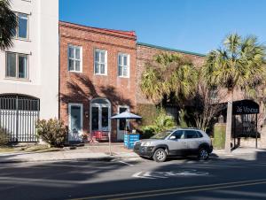 a car parked in front of a brick building at The Quarters on Vendue in Charleston