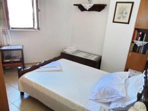 ein kleines Schlafzimmer mit einem Bett und einem Fenster in der Unterkunft Liolio's Manor in Agalianós