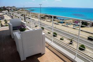 a balcony with a view of the ocean and a highway at Spuma di mare in Gallipoli