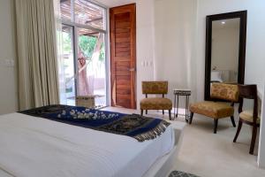 Säng eller sängar i ett rum på Hotel Casa de Campo Conkal Merida