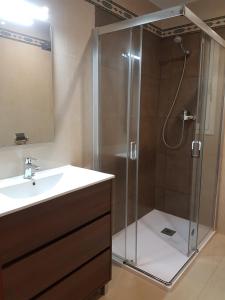 a bathroom with a shower and a sink at ApartSuits Tarragona Rambla Nova 24 in Tarragona +69 photos