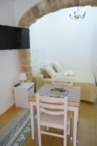 comedor con mesa y cama en Le Volte - Locazione Turistica, en Terrasini