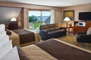 a hotel room with two beds and a balcony at Arrowwood Resort Hotel and Conference Center - Alexandria in Alexandria