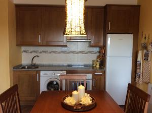 a kitchen with a table with a candle on it at Balcón De Garbisón in Roda de Isábena