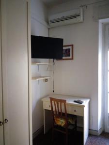 ローマにあるAlloggio turistico P.Lodiのデスク、壁掛けテレビが備わる客室です。