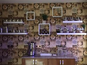 a room with a wall with a wallpaper with hats at Nourth House ApartHotel-شقق البيت الشمالي للشقق المفروشة in Al Qurayyat