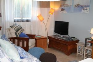 a living room with a couch and a tv at You & Me in Jávea