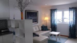 a living room with a couch and a table at Appartement Espinho in Espinho