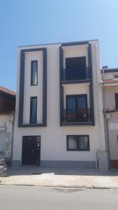 a white building with a letter on the side of it at Appartement Espinho in Espinho