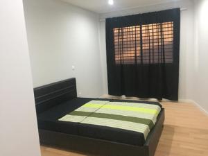 a bedroom with a bed in front of a window at T1 Família Luz in Mindelo