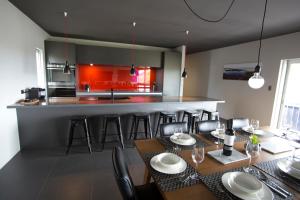 a kitchen and dining room with a table and chairs at Nelson Victoria Luxury Holiday Accommodation in Nelson