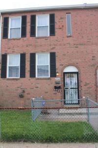 a brick building with a gate and a fence at Shanghai 2900 - Vintage Oriental Style 2BR w Parking near Airport in Philadelphia