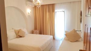Postel nebo postele na pokoji v ubytování Hotel Magdalena