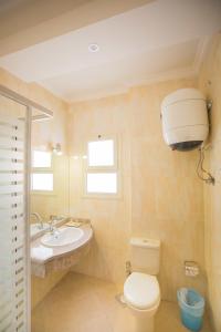 a bathroom with a toilet and a sink at Majorica Marina Hotel in El Alamein