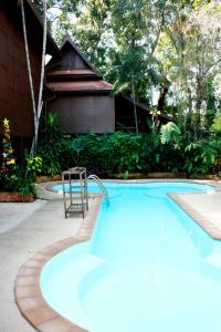 a swimming pool with a chair in front of a house at Club One Seven Gaymen Chiang Mai in Chiang Mai