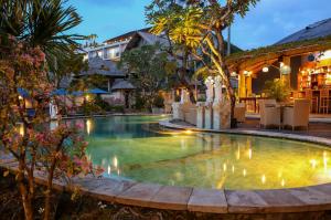 a swimming pool in a resort at night at The Amasya in Seminyak