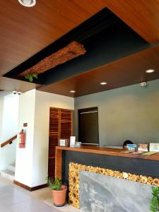 a living room with a fireplace and a flat screen tv at Acacia Garden Inn and Suites in Coron +61 photos