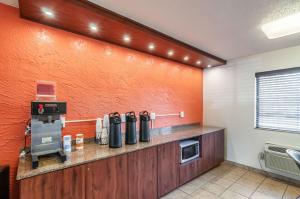 a kitchen with an orange wall at Motel 6-Naperville, IL in Naperville