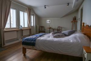 a bedroom with a large bed with two pillows on it at Cafe-Restaurant & Hotel Saima in Savonlinna