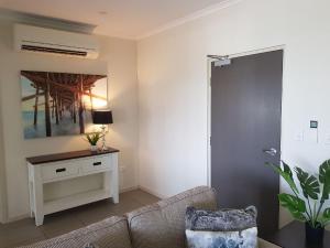 A bed or beds in a room at Darwin-Ocean views, tropical getaway, pool & aircon
