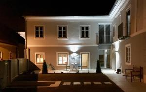 a white house at night with a table in front at Haus Franco in Bleiburg