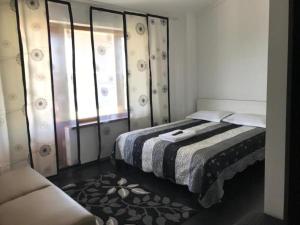 a bedroom with a bed and a couch in it at Bely Parus in Bosteri +62 photos