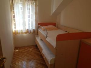 a small bedroom with a bunk bed and a window at Apartment Jana in Dubrovnik