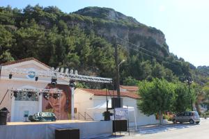 a building with a mural on the side of a mountain at Samaina Port Hotel in Karlovasi