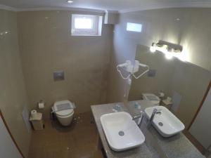 a bathroom with a sink and a toilet at Kalias Hotel in Vasiliki