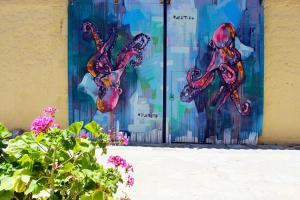 a painting of octopus on the side of a building at Samaina Port Hotel in Karlovasi