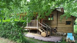 a log cabin with a staircase in front of it at Le Coeur De La Foret in Pierrefonds