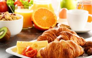 a breakfast table with croissants and other breakfast foods at Pirofani in Lefkada Town