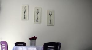 a table with chairs and spoons on a wall at Guest House Petricevic in Split