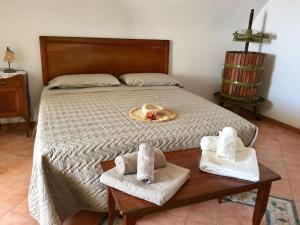 a bedroom with a bed with towels on a table at Casa Rosetta in Praiano