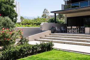 a garden with stairs leading to a house at Villa Ismini in Kato Daratso