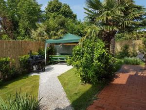 a garden with a picnic table and a gazebo at KEI apartment in Portorož