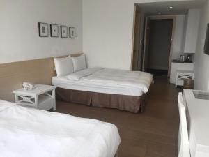 Voodi või voodid majutusasutuse Wemeet Hotel Taipei toas