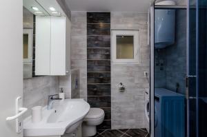 a bathroom with a sink and a toilet and a shower at Apartments A&M in Dubrovnik