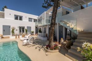 an exterior view of a house with a swimming pool at Oniro Suites, a member of Mykonos Highlights in Mikonos