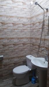 a bathroom with a toilet and a sink at Hostel City Center in Kutaisi +44 photos