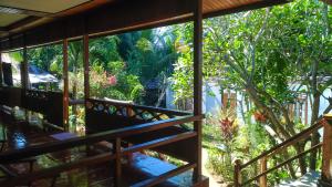 a view of a garden from the balcony of a house at Panorama Backpackers in Bunaken