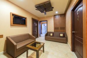 a living room with a couch and a tv at Treebo Trend Nestlay Casa in Chennai