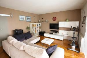 a living room with a couch and a tv at Vrata Jadrana in Rijeka