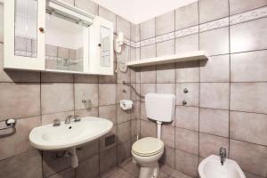 a bathroom with a toilet and a sink at Vrata Jadrana in Rijeka +22 photos