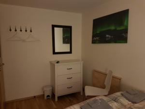 a bedroom with a bed and a desk and a chair at House on the Hill in Höfn