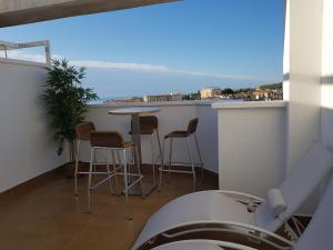 a balcony with a table and chairs and a view at Apartamento Mediterraneo Guardamar in Guardamar del Segura